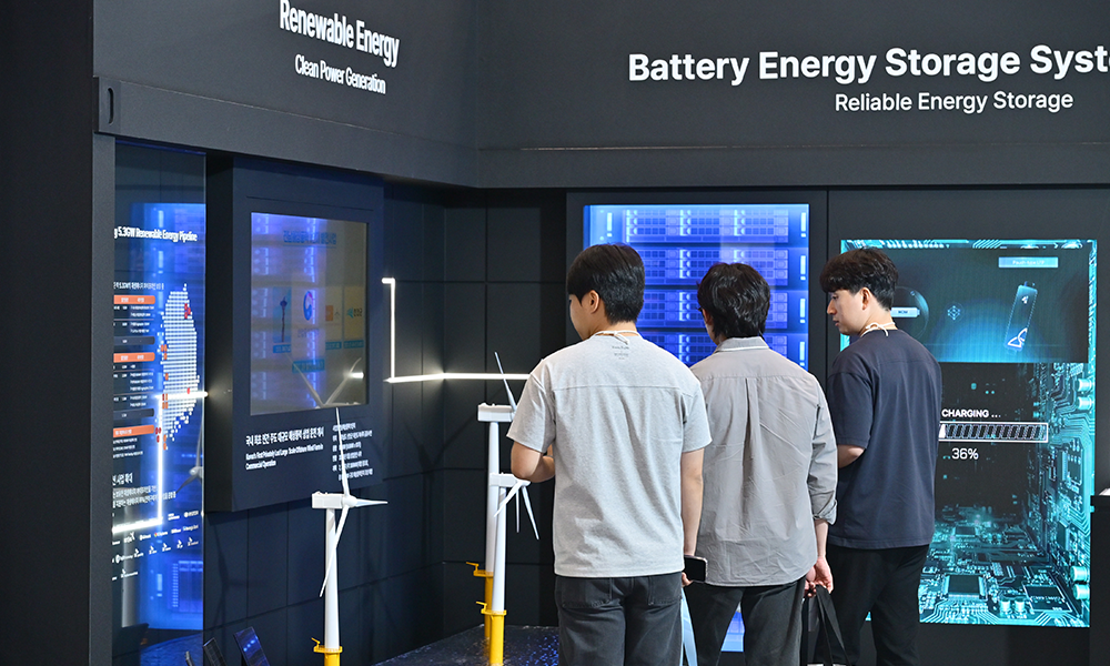 '2026 기후산업국제박람회(WCE)' SK 전시관의 재생에너지(Renewable Energy) & BESS(Battery Energy Storage) 존에서 관람객들이 SK이노베이션 E&S의 글로벌 재생에너지 사업 현황과 배터리 모형을 살펴보고 있다